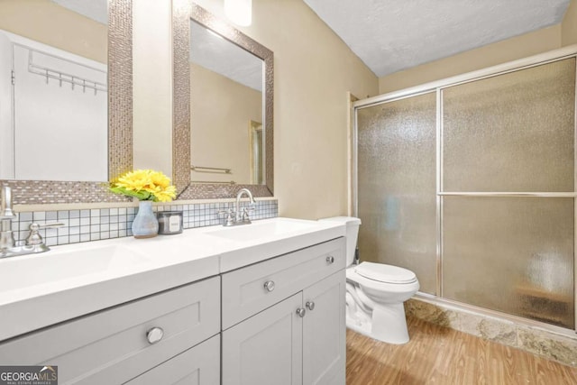 2952 N Dekalb Dr Unit C, Atlanta, GA 30340 - full bath with double vanity, backsplash, a shower with door, wood finished floors, and a textured ceiling