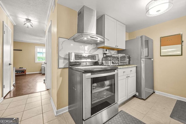2952 N Dekalb Dr Unit C, Atlanta, GA 30340 - kitchen with stainless steel appliances, wall chimney range hood, light tile patterned floors, white cabinetry, and light countertops