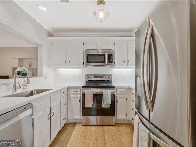 212 Abingdon Way, Sandy Springs, GA 30328 - kitchen featuring appliances with stainless steel finishes, a sink, white cabinets, light countertops, and light wood-type flooring