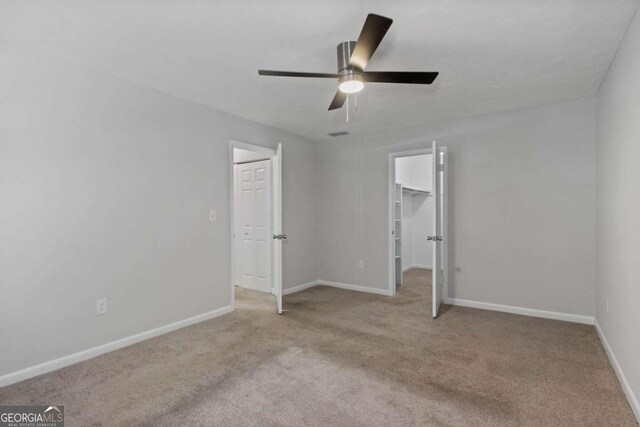 1150 Collier Rd NW Unit 6H, Atlanta, GA 30318 - empty room with carpet, ceiling fan, and baseboards