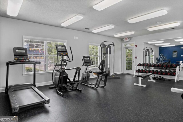 1150 Collier Rd NW Unit 6H, Atlanta, GA 30318 - workout area featuring a textured ceiling and baseboards