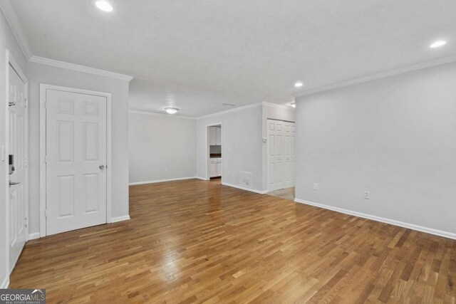 1150 Collier Rd NW Unit 6H, Atlanta, GA 30318 - spare room with light wood finished floors, baseboards, recessed lighting, and ornamental molding