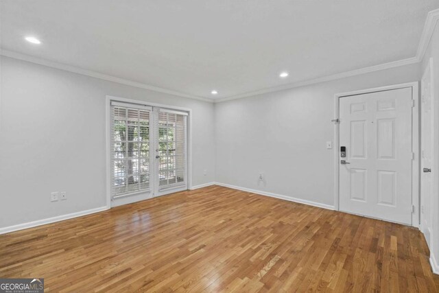 1150 Collier Rd NW Unit 6H, Atlanta, GA 30318 - spare room with crown molding, light wood-type flooring, recessed lighting, and baseboards
