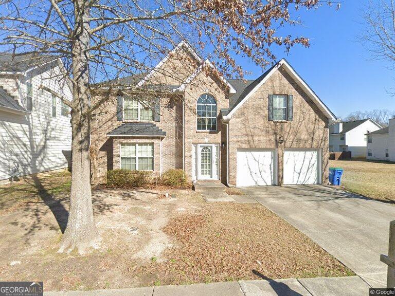 4466 Estate St, South Fulton, GA 30349 - traditional-style home with an attached garage, concrete driveway, and brick siding