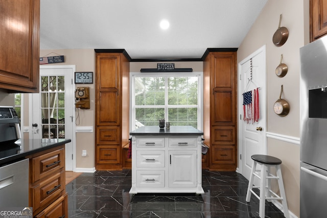 341 Jodeco Station Cir E, Stockbridge, GA 30281 - kitchen with stainless steel fridge with ice dispenser, baseboards, dark countertops, and dark marble finish floors