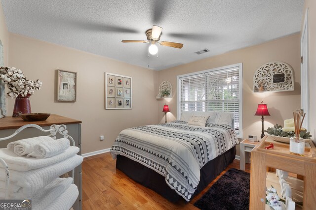 341 Jodeco Station Cir E, Stockbridge, GA 30281 - bedroom featuring wood finished floors, baseboards, a textured ceiling, and ceiling fan