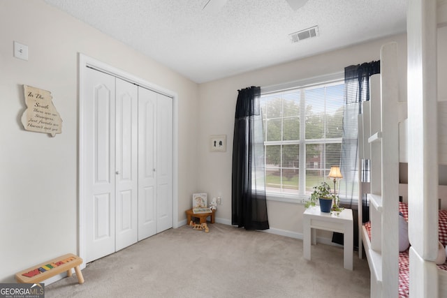 341 Jodeco Station Cir E, Stockbridge, GA 30281 - carpeted bedroom featuring a closet, a textured ceiling, and baseboards