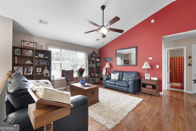 341 Jodeco Station Cir E, Stockbridge, GA 30281 - living room featuring a ceiling fan, vaulted ceiling, hardwood / wood-style floors, and a textured ceiling