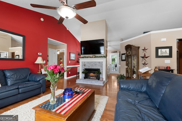 341 Jodeco Station Cir E, Stockbridge, GA 30281 - living area featuring a ceiling fan, vaulted ceiling, a fireplace, wood finished floors, and baseboards
