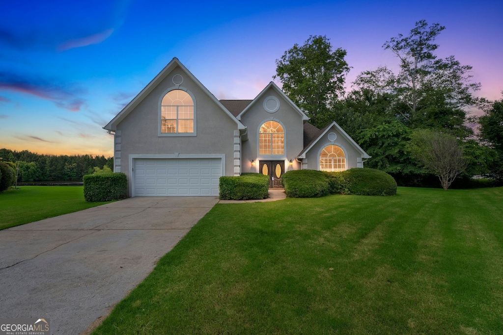 164 Gleneagles Way, Fayetteville, GA 30215 - traditional-style home with a garage, a lawn, concrete driveway, and stucco siding