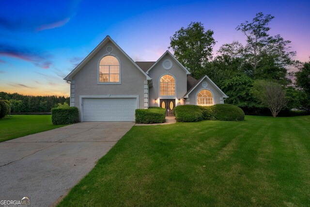 164 Gleneagles Way, Fayetteville, GA 30215 - traditional-style home with a garage, a lawn, concrete driveway, and stucco siding