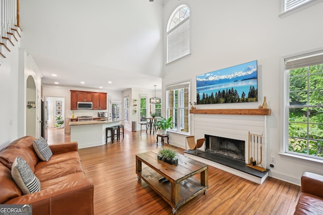 75 Vinings Lake Dr SW, Mableton, GA 30126 - living area featuring healthy amount of natural light, a high ceiling, light wood-type flooring, a fireplace with raised hearth, and recessed lighting