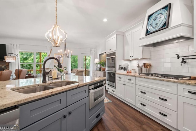 175 Stoneledge Trce N, Jasper, GA 30143 - kitchen with a sink, custom exhaust hood, gray cabinets, a chandelier, and tasteful backsplash