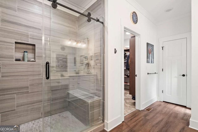 175 Stoneledge Trce N, Jasper, GA 30143 - bathroom featuring wood finished floors, a shower stall, crown molding, baseboards, and a spacious closet