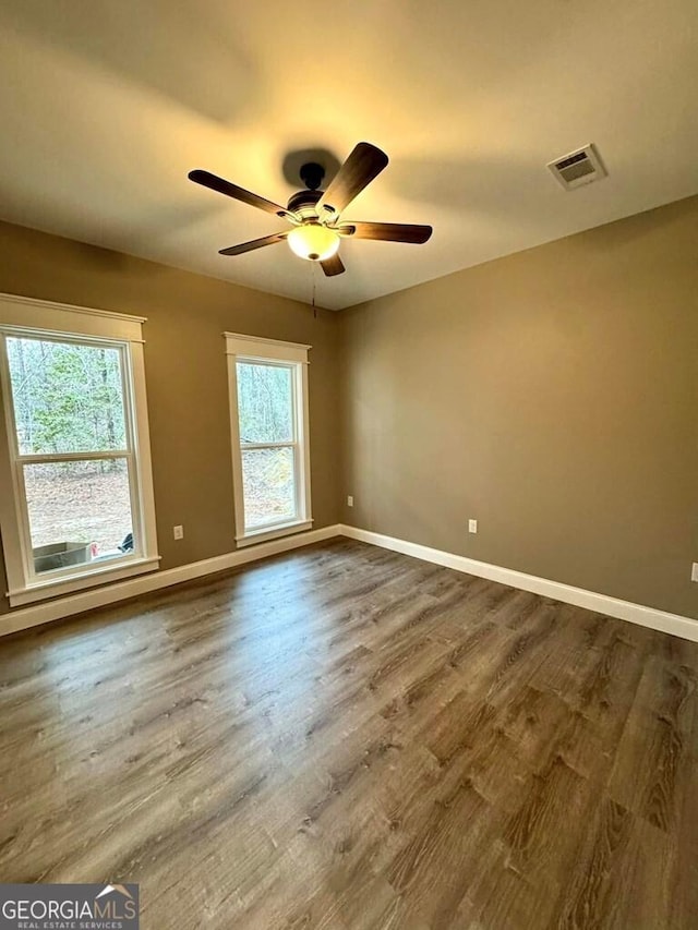 1231 Whipples Crossing Rd, Dudley, GA 31022 - spare room with a ceiling fan, dark wood-style floors, and plenty of natural light