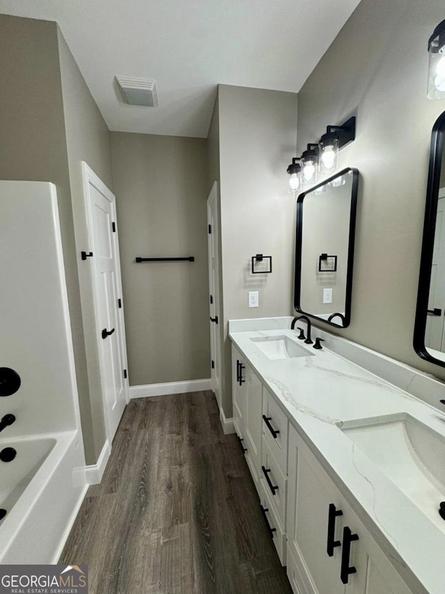 1231 Whipples Crossing Rd, Dudley, GA 31022 - full bath featuring wood finished floors and double vanity