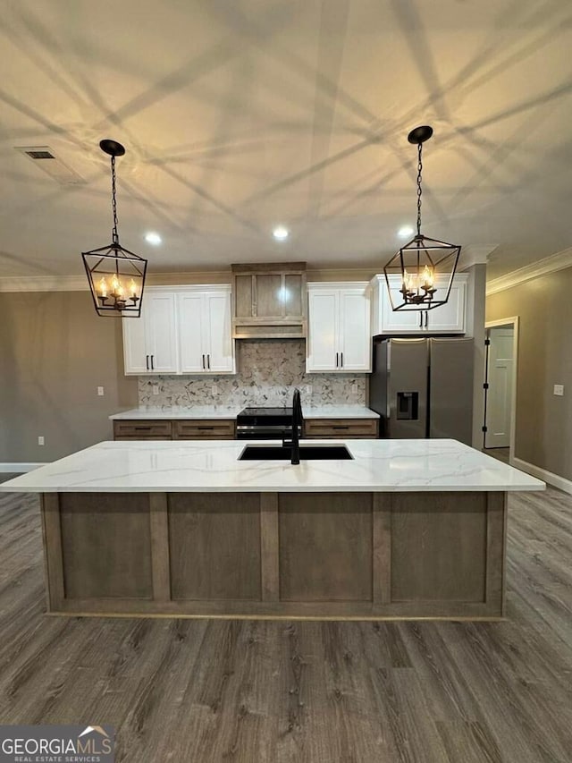 1231 Whipples Crossing Rd, Dudley, GA 31022 - kitchen with stainless steel refrigerator with ice dispenser, ornamental molding, under cabinet range hood, dark wood-style flooring, and white cabinets