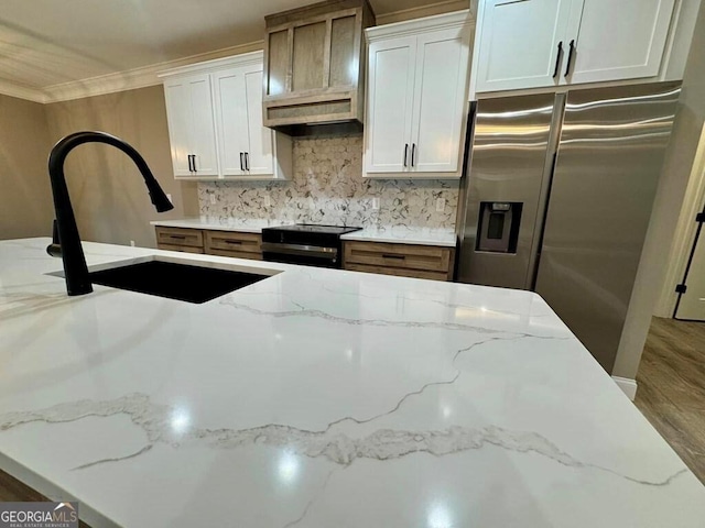 1231 Whipples Crossing Rd, Dudley, GA 31022 - kitchen with stainless steel appliances, crown molding, backsplash, light stone counters, and wood finished floors