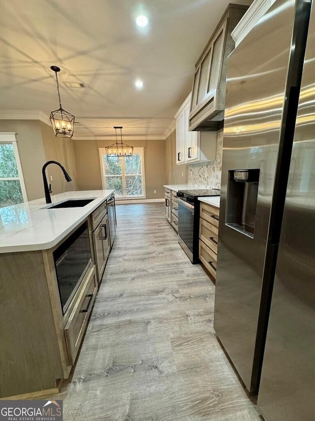 1231 Whipples Crossing Rd, Dudley, GA 31022 - kitchen with stainless steel appliances, ornamental molding, a chandelier, recessed lighting, and light countertops