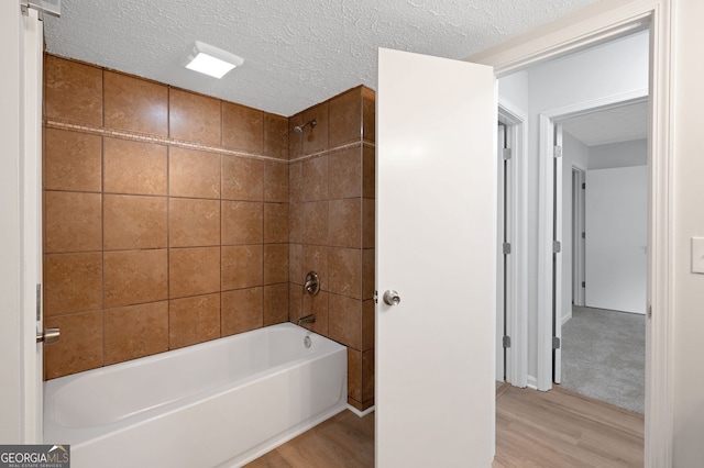 112 Valley Rd, Stockbridge, GA 30281 - full bathroom with wood finished floors, bathtub / shower combination, and a textured ceiling