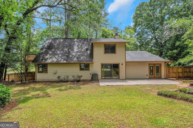 112 Valley Rd, Stockbridge, GA 30281 - back of property featuring a chimney, a patio area, central AC unit, french doors, and a shingled roof