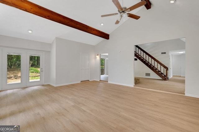 112 Valley Rd, Stockbridge, GA 30281 - unfurnished living room featuring beam ceiling, plenty of natural light, stairs, light wood-style floors, and baseboards
