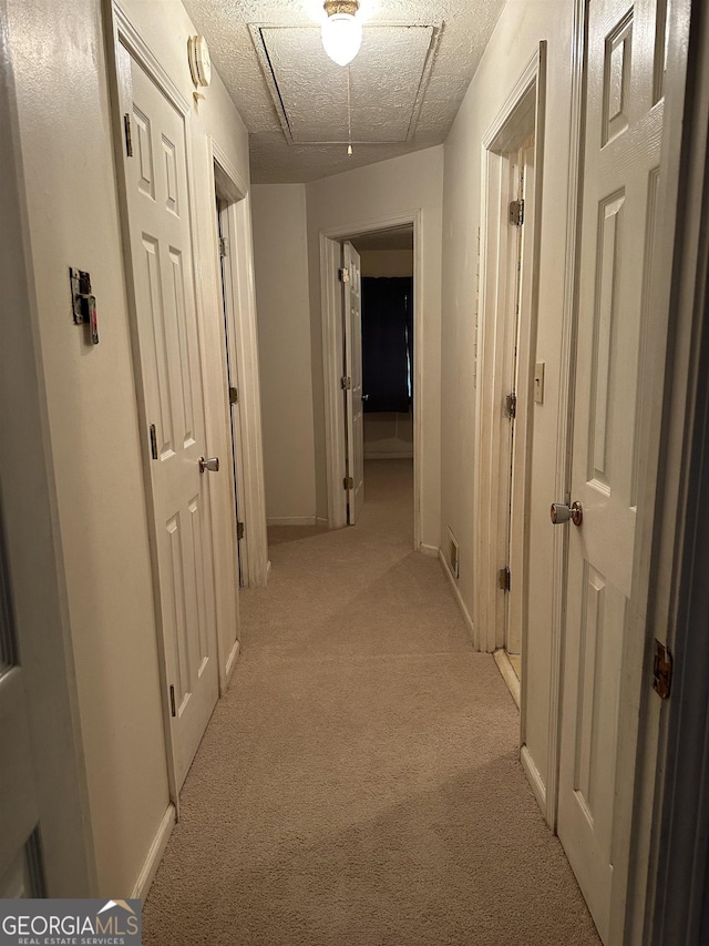 984 Morrow Rd, Morrow, GA 30260 - hallway featuring light colored carpet, baseboards, and attic access