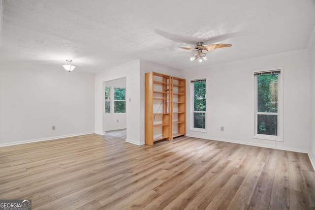 5157 Roswell Rd Unit 1, Atlanta, GA 30342 - empty room with ceiling fan, wood finished floors, baseboards, and a textured ceiling