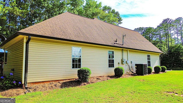 6830 Peeksville Rd, Mcdonough, GA 30252 - view of property exterior featuring central air condition unit, a lawn, and a shingled roof