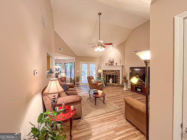6830 Peeksville Rd, Mcdonough, GA 30252 - living room featuring light wood-style flooring, a ceiling fan, high vaulted ceiling, and a stone fireplace