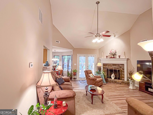 6830 Peeksville Rd, Mcdonough, GA 30252 - living room with wood finished floors, ceiling fan, a fireplace, and high vaulted ceiling