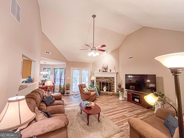 6830 Peeksville Rd, Mcdonough, GA 30252 - living room with a ceiling fan, light wood-type flooring, high vaulted ceiling, and a fireplace