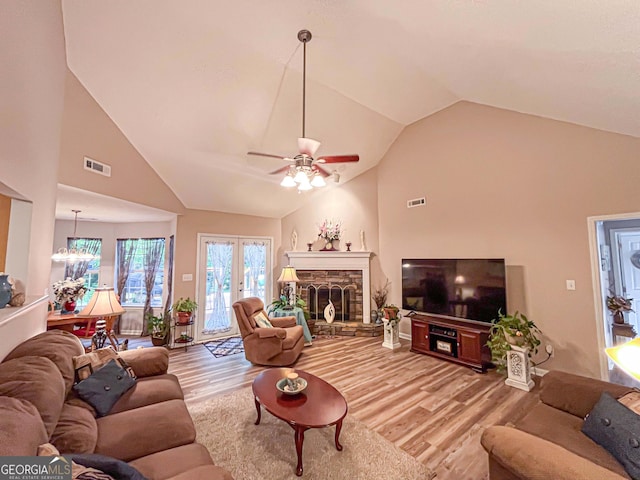 6830 Peeksville Rd, Mcdonough, GA 30252 - living room with light wood-style flooring, ceiling fan, a fireplace, and high vaulted ceiling