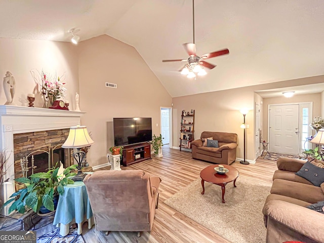 6830 Peeksville Rd, Mcdonough, GA 30252 - living room with a ceiling fan, wood finished floors, baseboards, high vaulted ceiling, and a fireplace