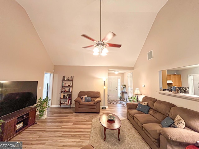 6830 Peeksville Rd, Mcdonough, GA 30252 - living room with high vaulted ceiling, light wood-type flooring, a ceiling fan, and baseboards