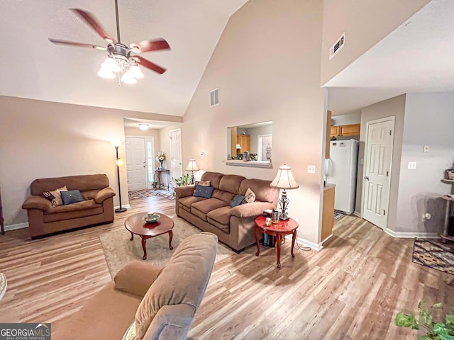 6830 Peeksville Rd, Mcdonough, GA 30252 - living area with light wood finished floors, high vaulted ceiling, ceiling fan, and baseboards
