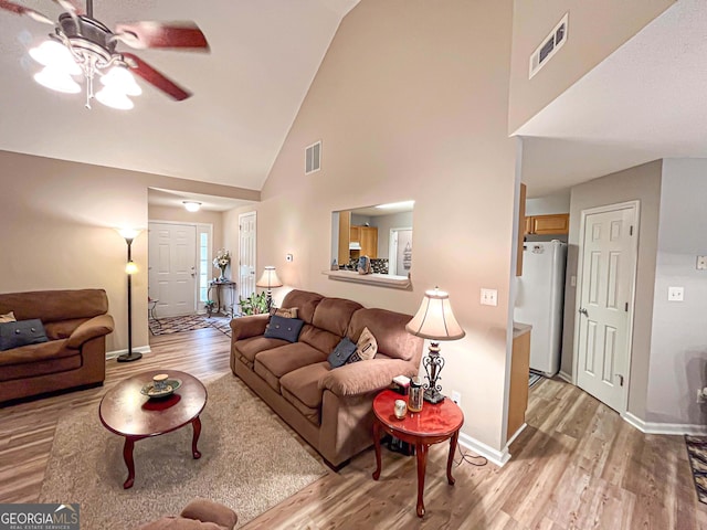 6830 Peeksville Rd, Mcdonough, GA 30252 - living room with ceiling fan, light wood finished floors, high vaulted ceiling, and baseboards