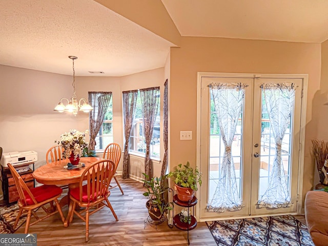 6830 Peeksville Rd, Mcdonough, GA 30252 - dining area featuring a chandelier, wood finished floors, french doors, a textured ceiling, and baseboards
