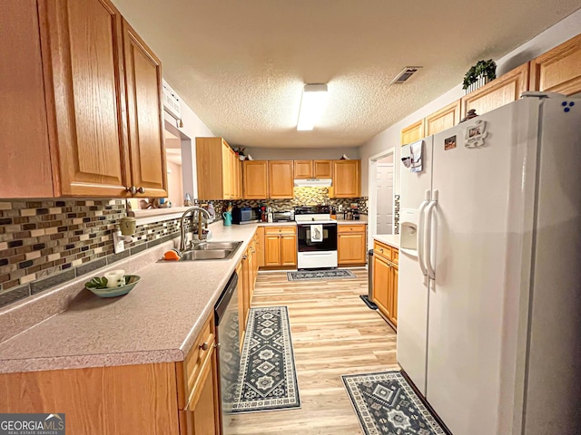 6830 Peeksville Rd, Mcdonough, GA 30252 - kitchen with white appliances, a sink, light wood-style floors, tasteful backsplash, and light countertops