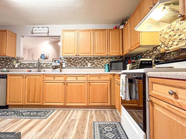 6830 Peeksville Rd, Mcdonough, GA 30252 - kitchen featuring range with electric stovetop, under cabinet range hood, black microwave, light countertops, and backsplash