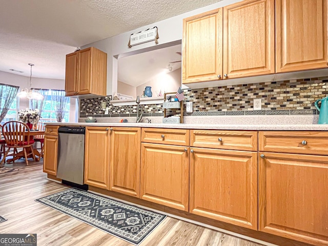 6830 Peeksville Rd, Mcdonough, GA 30252 - kitchen featuring stainless steel dishwasher, light wood-type flooring, light countertops, decorative backsplash, and a chandelier