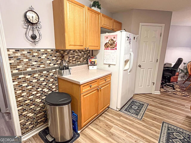 6830 Peeksville Rd, Mcdonough, GA 30252 - kitchen with light wood-style floors, white fridge with ice dispenser, and decorative backsplash