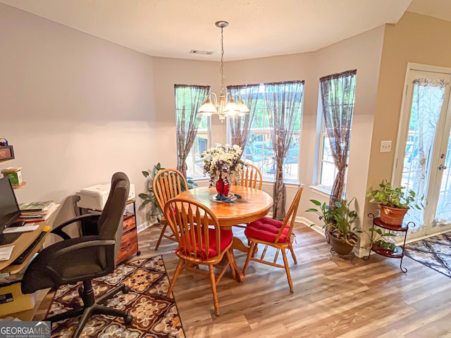 6830 Peeksville Rd, Mcdonough, GA 30252 - dining space featuring a chandelier, light wood-style flooring, and baseboards