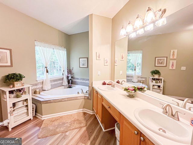 6830 Peeksville Rd, Mcdonough, GA 30252 - full bath featuring wood finished floors, double vanity, and a garden tub