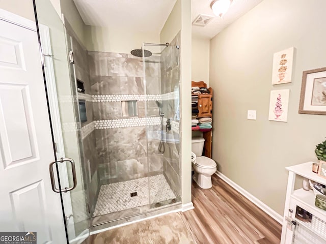 6830 Peeksville Rd, Mcdonough, GA 30252 - full bathroom featuring toilet, wood finished floors, a stall shower, and baseboards