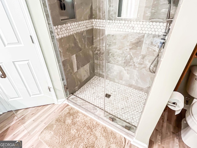 6830 Peeksville Rd, Mcdonough, GA 30252 - full bathroom featuring toilet, a stall shower, and wood finished floors
