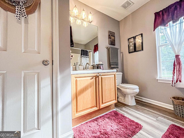 6830 Peeksville Rd, Mcdonough, GA 30252 - full bathroom with toilet, vanity, wood finished floors, baseboards, and a shower with curtain