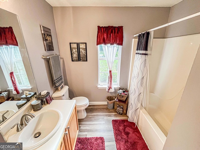 6830 Peeksville Rd, Mcdonough, GA 30252 - full bath with toilet, vanity, wood finished floors, shower / bath combo with shower curtain, and baseboards