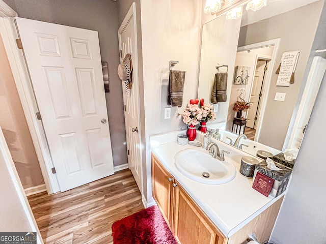 6830 Peeksville Rd, Mcdonough, GA 30252 - bathroom with vanity, wood finished floors, and baseboards