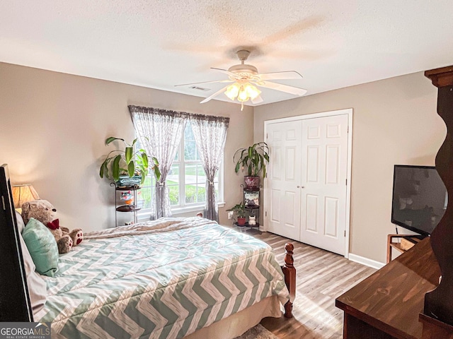 6830 Peeksville Rd, Mcdonough, GA 30252 - bedroom featuring wood finished floors, ceiling fan, baseboards, a closet, and a textured ceiling